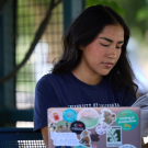 Student looking at laptop outside