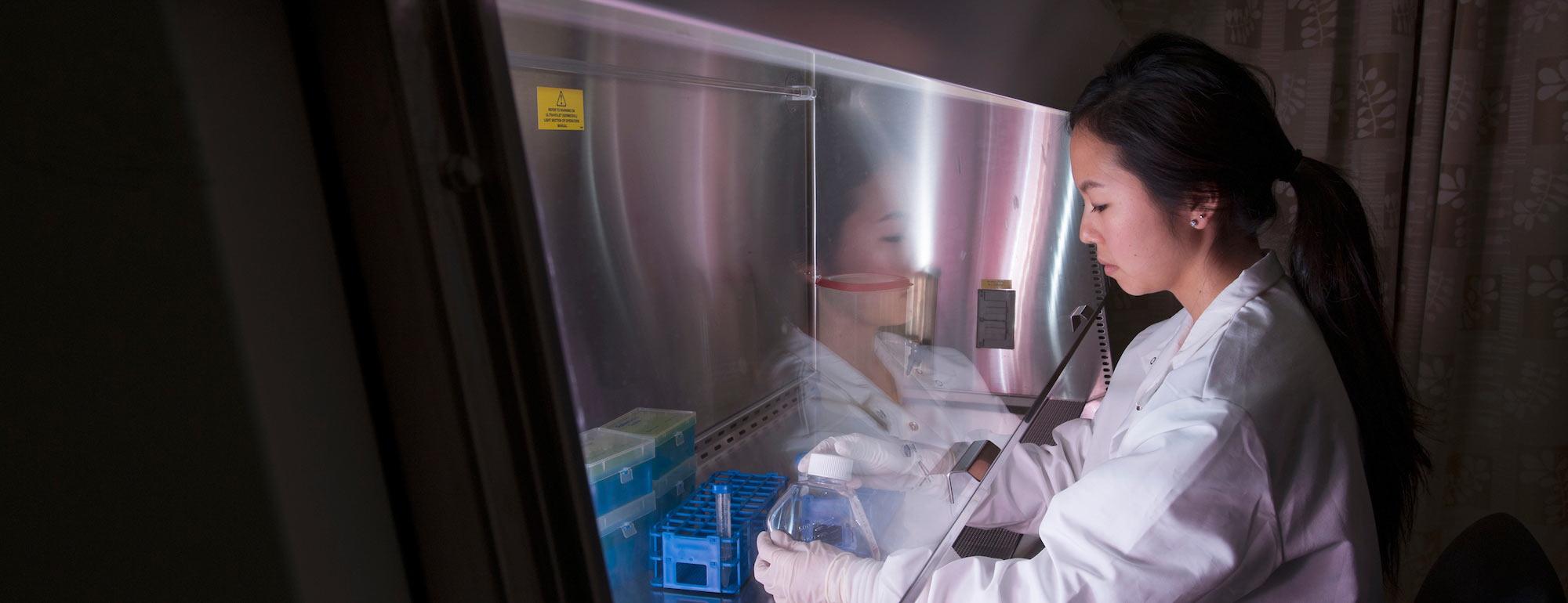 A student in a lab works with samples