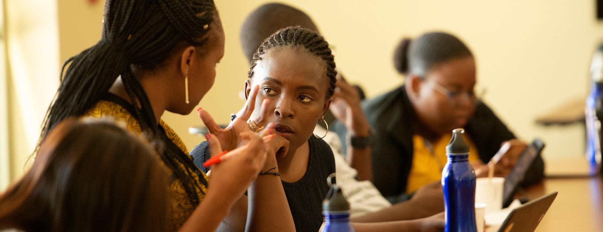 Two female students discuss an issue