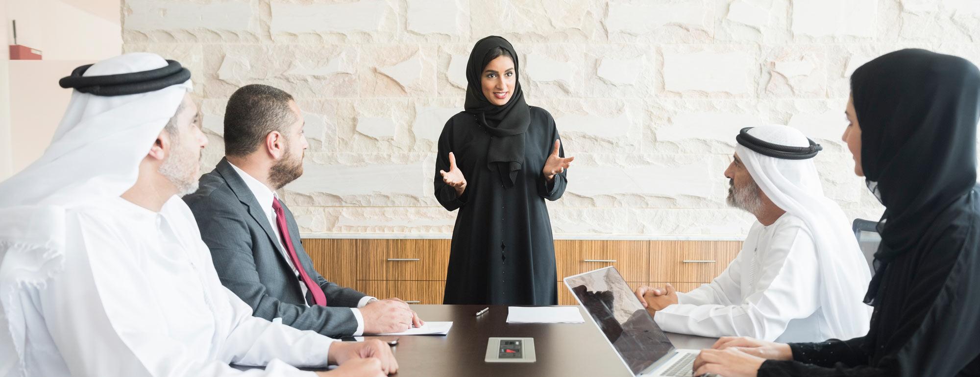 A female gives a presentation to her colleagues