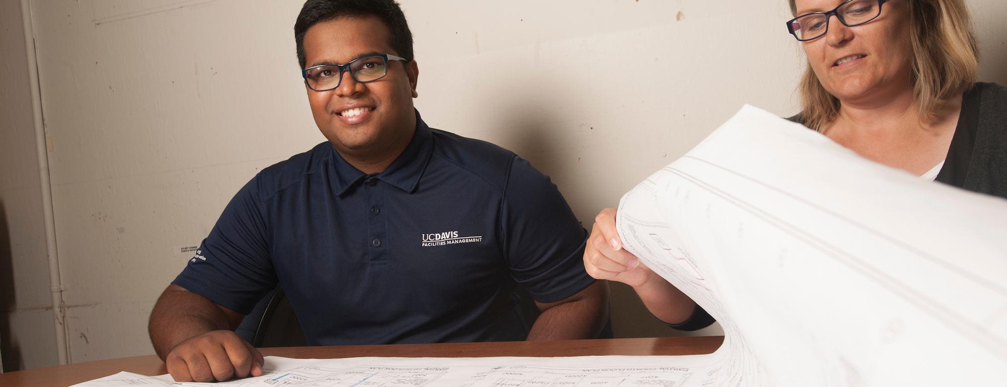 A student smiles over a city planning map