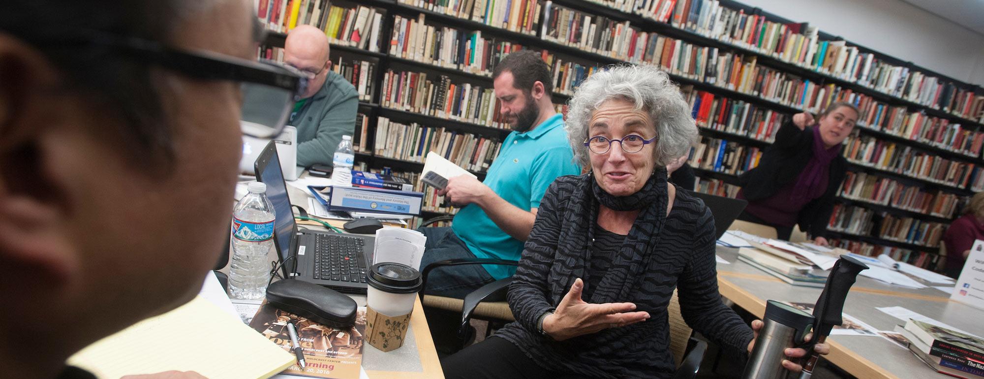 An older women speaks with someone in the foreground