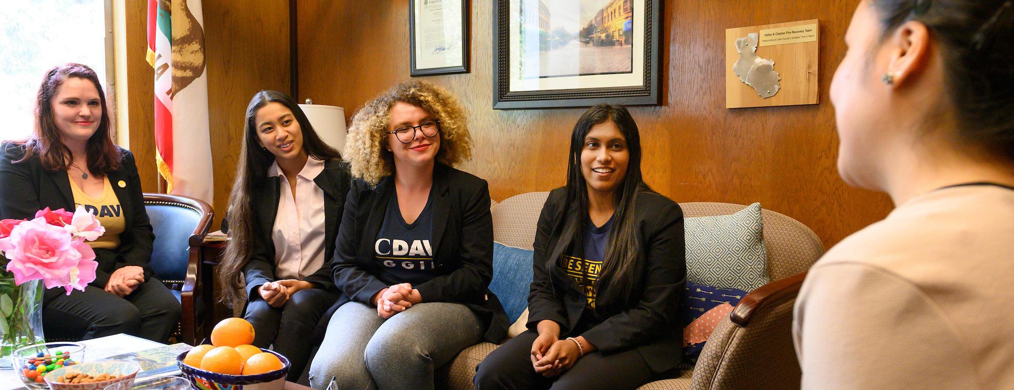 a group of female students having a discussion