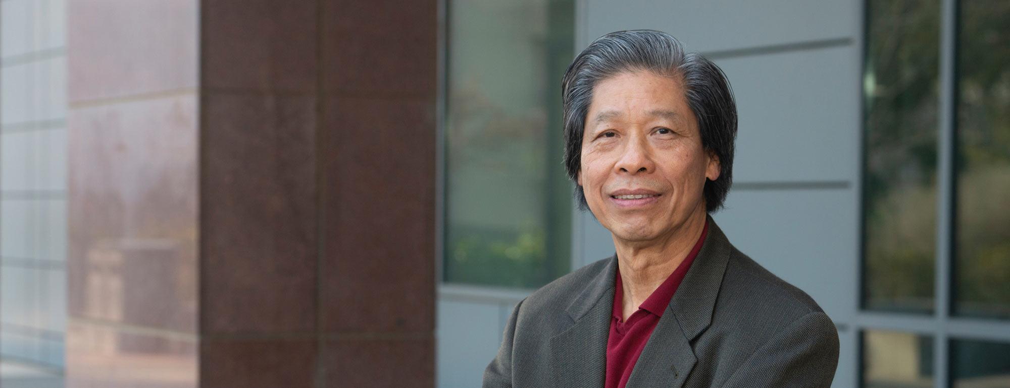 Proffesor Lam poses for a picture near the genomics building