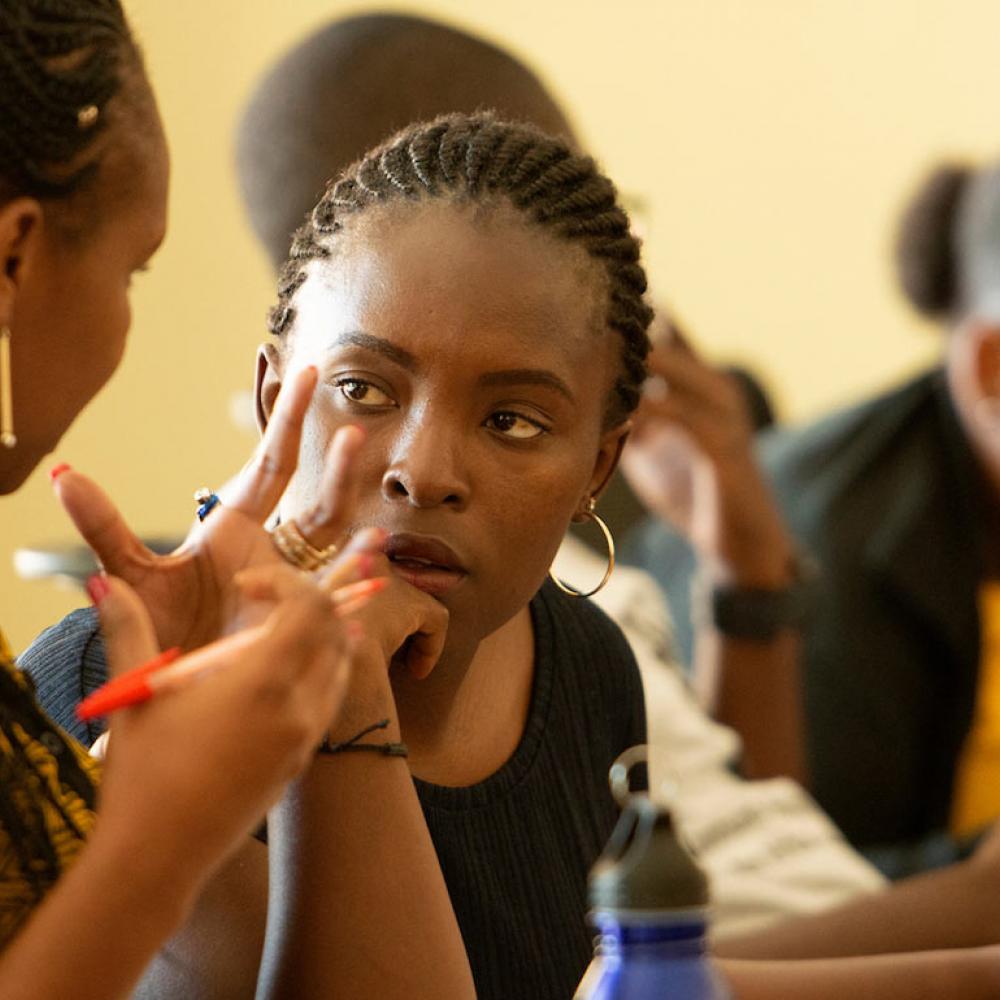 Two female students discuss an issue