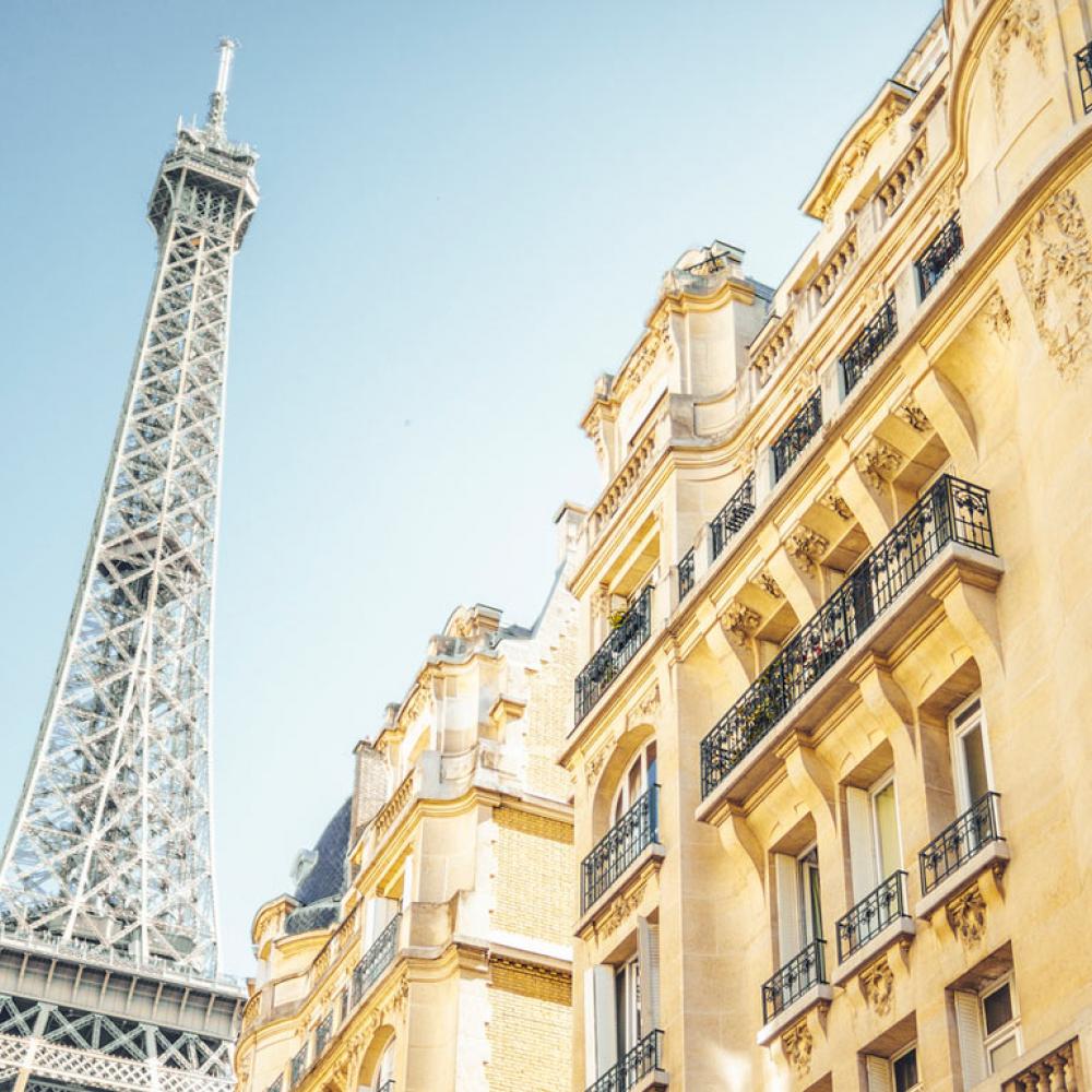 A view of the Eiffel Tower from a Parisian street