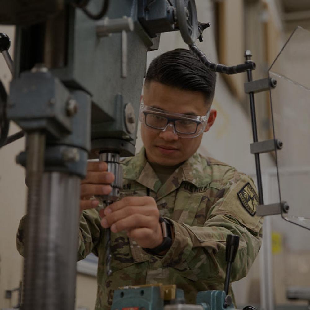 A ROTC student works a machine press