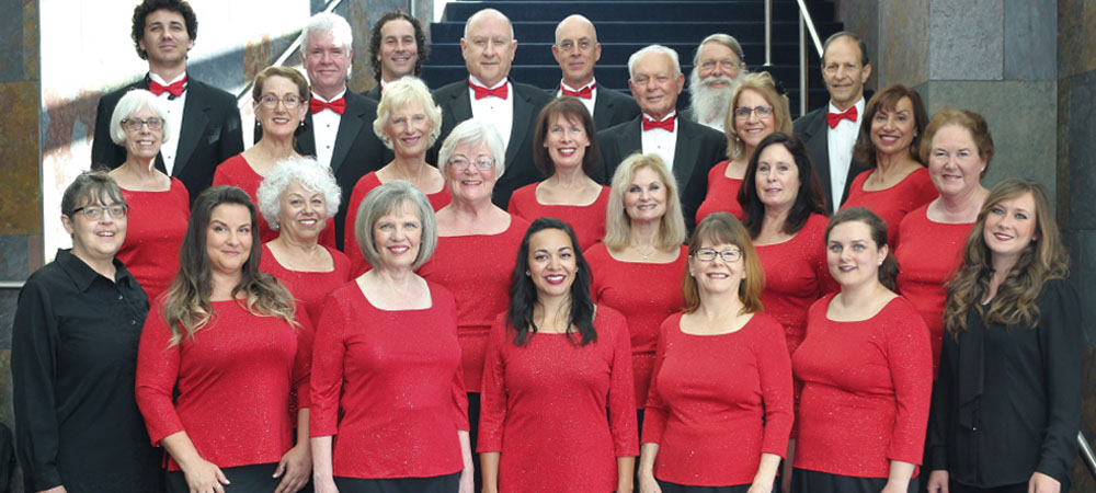 Members of the Cantare Chorale standing on stage.