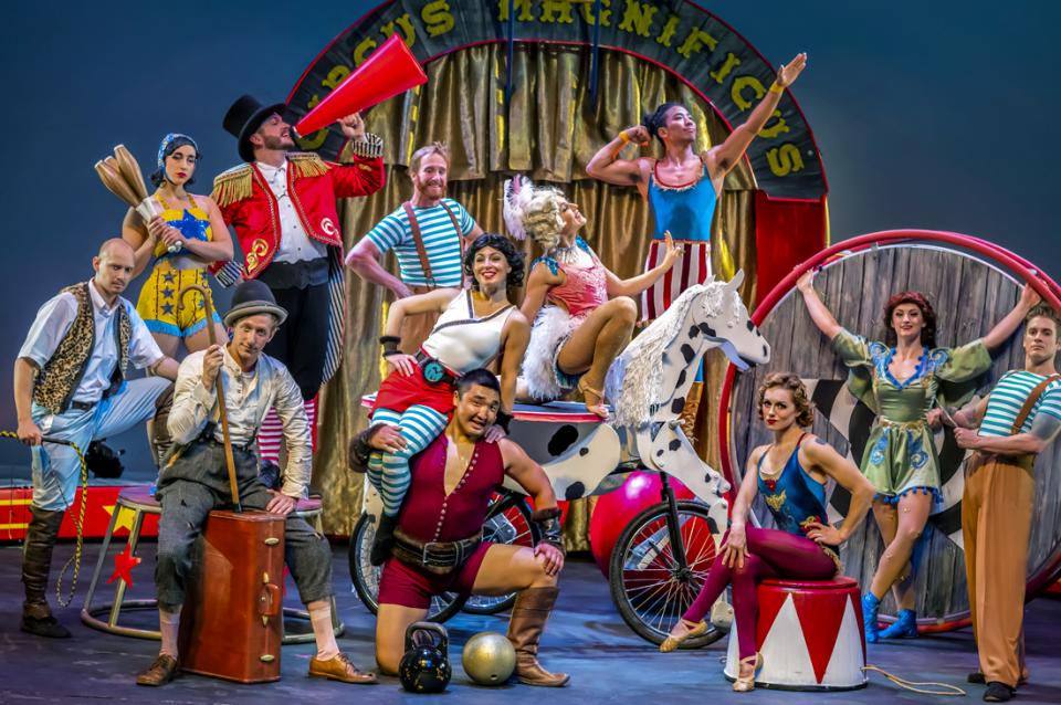 Members of the circus troupe posing on stage in costume.