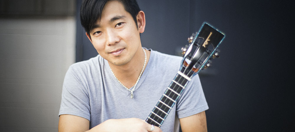 Jake Shimabukuro holding a ukelele.