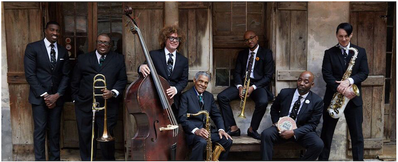 Members of the band posing with their instruments.