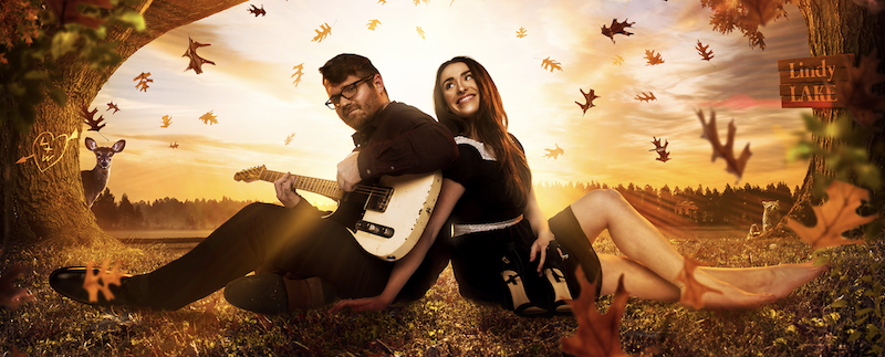 Laurel Wright and Wesley Lunsford of the Young Fables, sitting on the ground under trees with leaves falling.