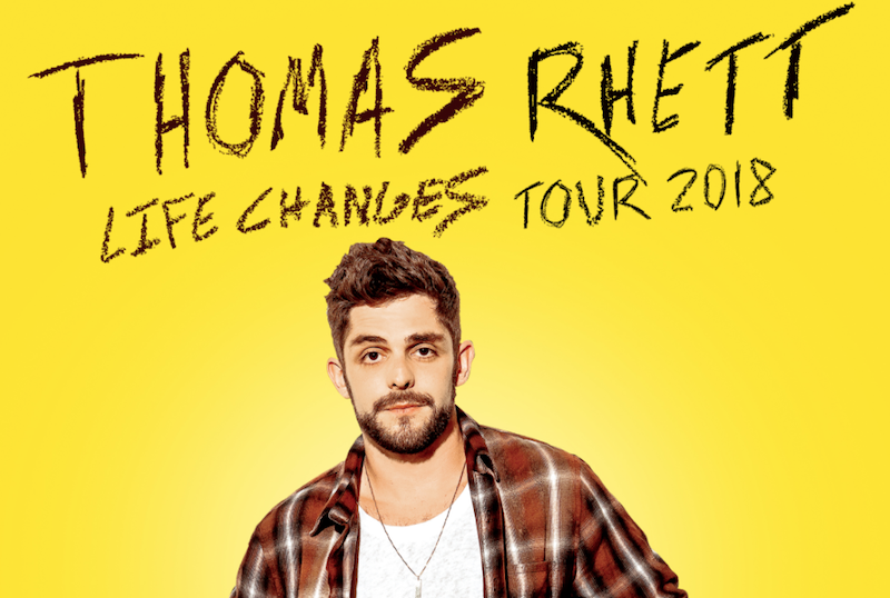 SInger Thomas Rhett standing in front of a yellow background.