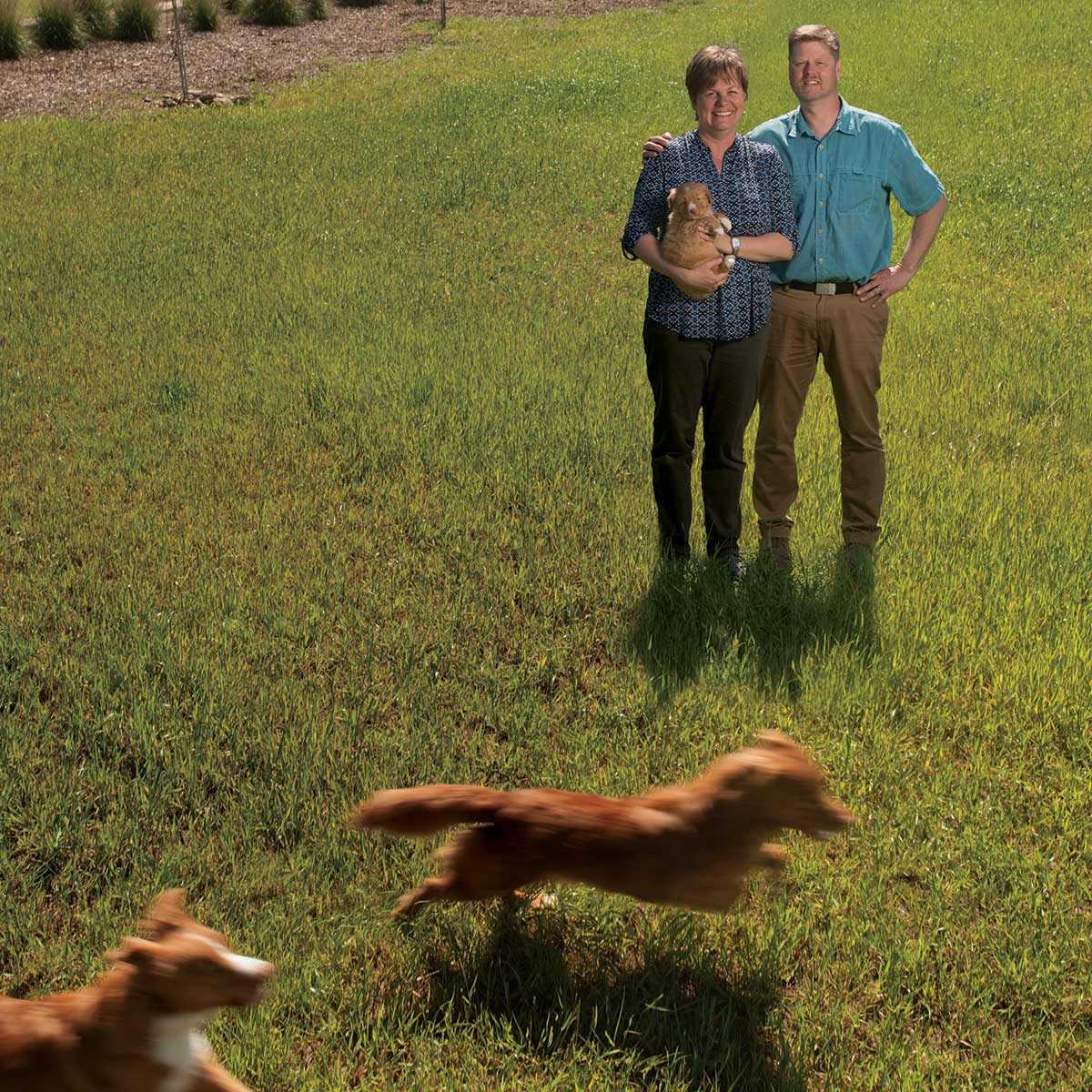 Danika and Mike Bannasch on their farm with their dogs