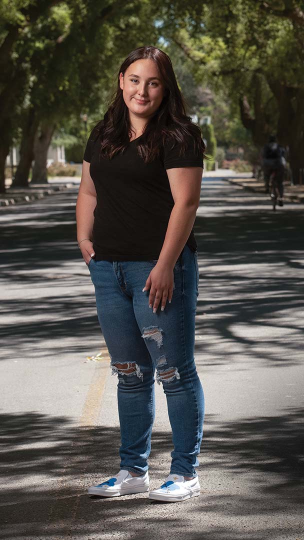 A student stands on the UC Davis campus
