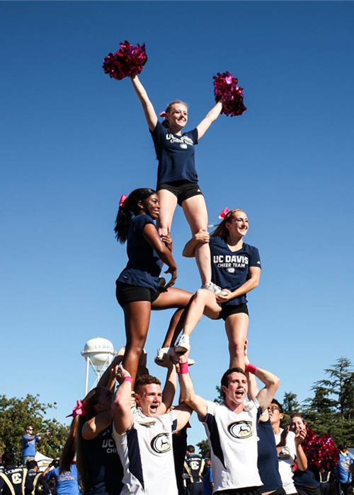 Megan Bull at the top of the pyramid with the UC Davis Cheer Team