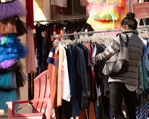 A person shops for secondhand clothing