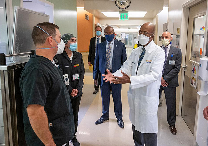 Chancellor May visits the UC Davis Medical Center with UC President Michael V. Drake, a physician, in white coat, September 2021, amid the pandemic.