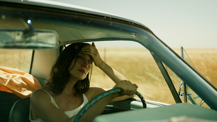 Emily Somers drives a car in her role in the film Into the Valley