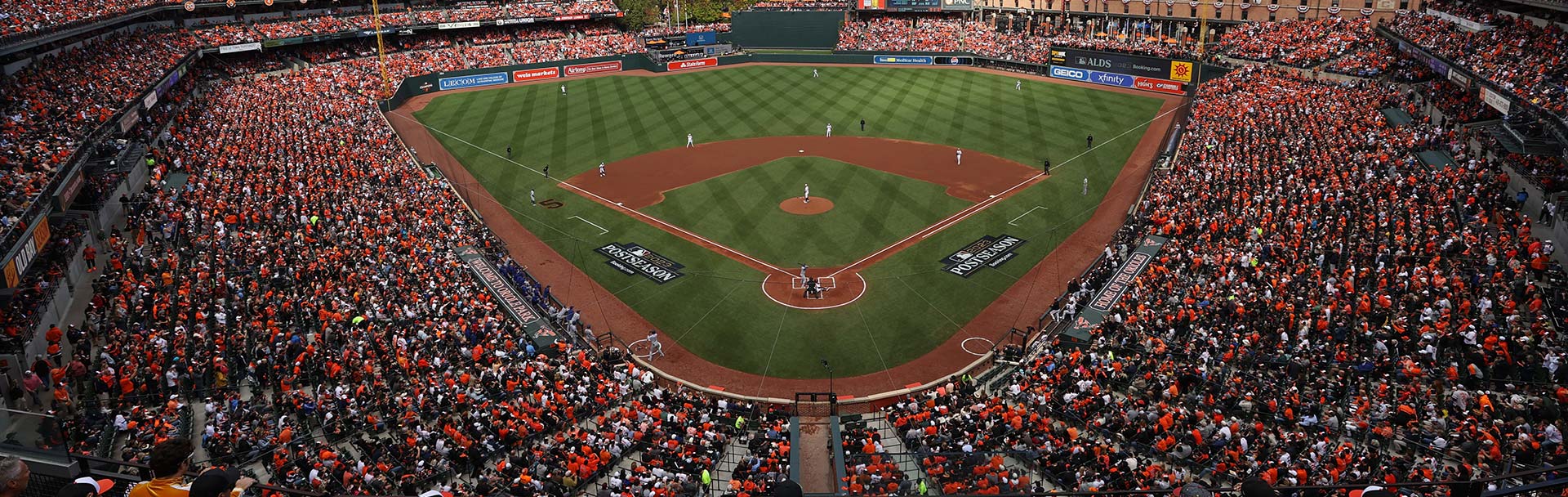Wide-angle photo of a sold-out home Orioles game. The view is from behind home plate, high up in the stands. The left and right field stands are seen.